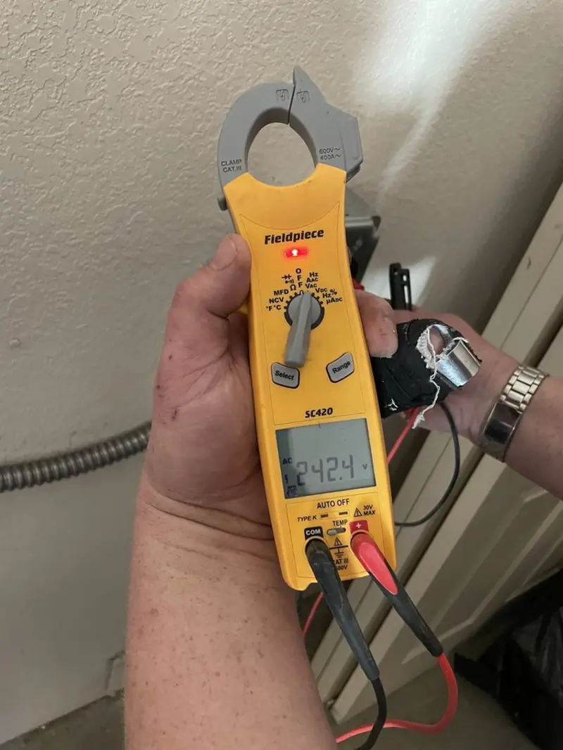 Voltage testing with clamp meter during Outlet Installation in Festus